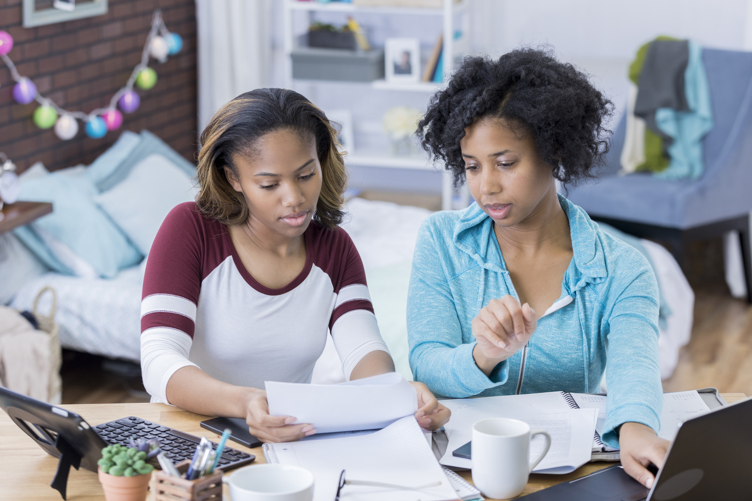 student and mom sitting at computer discussing paperwork